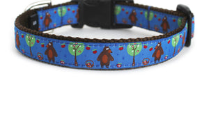 Handmade dog collar with royal blue trim, featuring a cute bear in the woods picking apples.