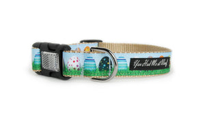 Easter Dog Collar with khaki webbing and colorful trim that looks like real Easter eggs sitting in the grass with light blue sky above, featuring an optional reflective buckle.