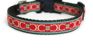 Charming Dog Collar in red with green four leaf clovers, and golden hearts and horseshoes atop olive green webbing.