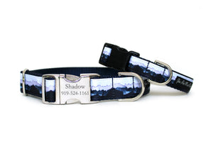 A dog collar with a serene navy blue mountain landscape and misty mountains, featuring an optional personalized aluminum buckle, shown with a small collar. 