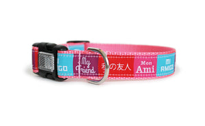 A dog collar featuring colorful blocks of text, each with the word "my friend" in different languages: Japanese, English, French, and Spanish, with pink webbing and an optional reflective buckle.