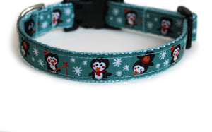 Holiday dog collar with light aqua blue trim, featuring adorable penguins fishing in the snow.