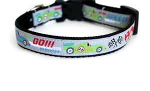 Dog Collar with black webbing and light gray trim, with red, lime green, and light blue race cars, and checkered flags and the text, Go!.